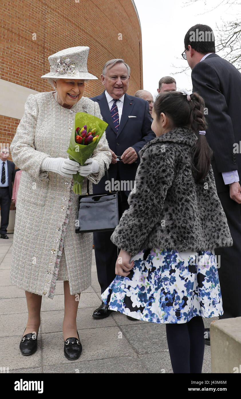 Queen Elizabeth II is accompanied by Chair of Governors, Roger Laneknott (second left) during a visit to Pangbourne College in Berkshire to celebrate its centenary. Stock Photo