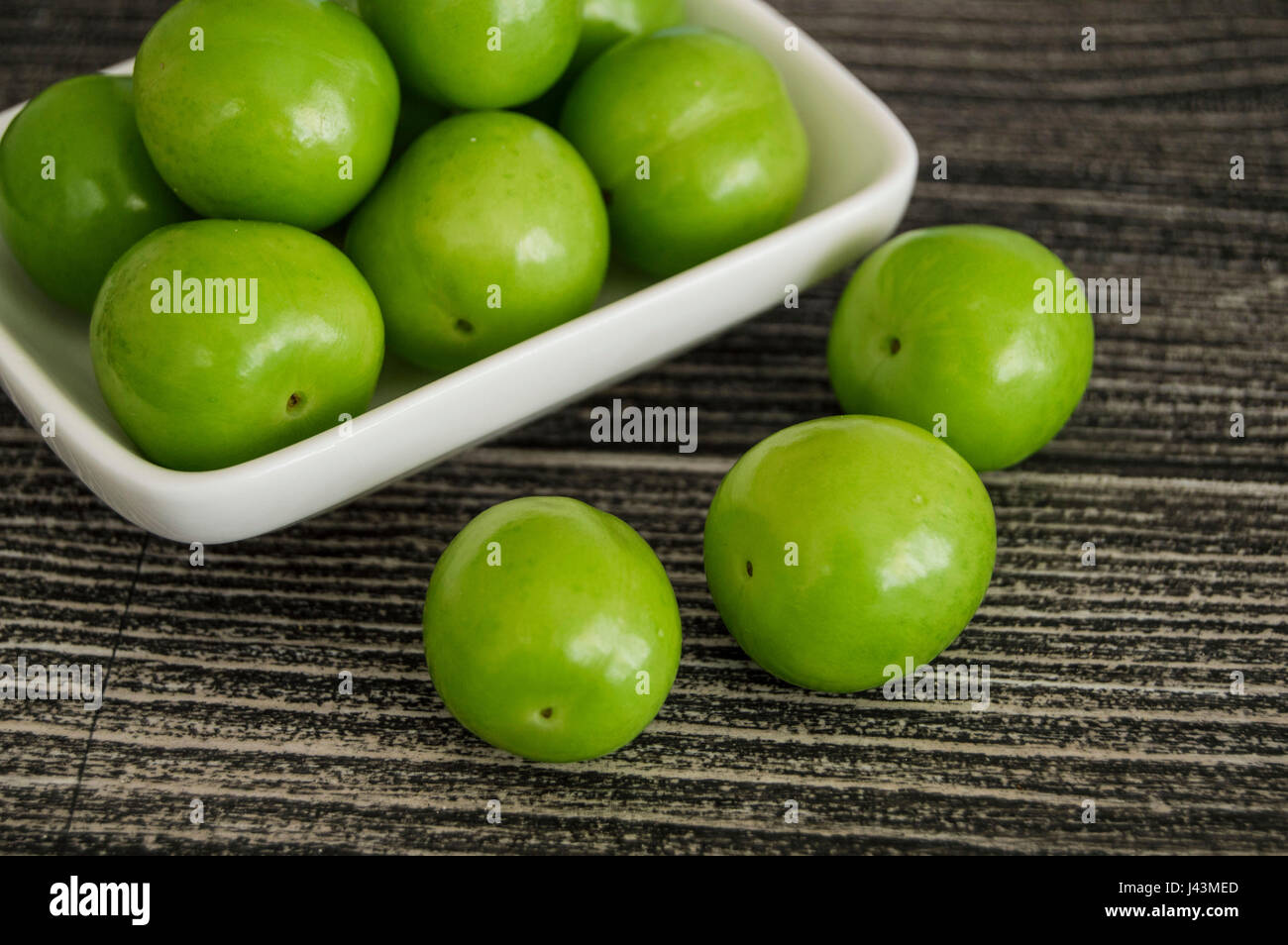 Sour green plum, the most wonderful and mouth watering sour plums Stock