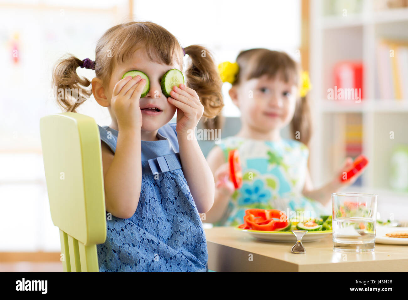 kids eating healthy food in kindergarten or at home Stock Photo