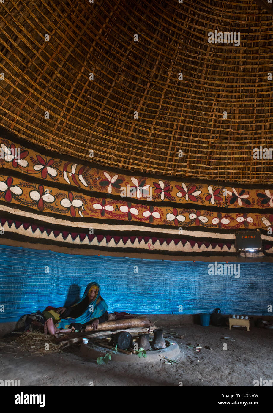Ethiopian woman inside her traditional painted and decorated house
