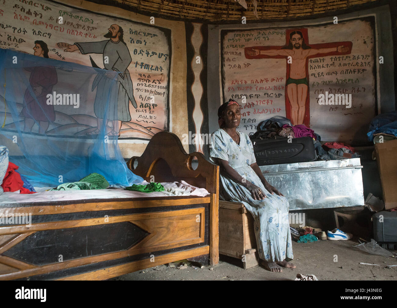 Ethiopian woman inside her traditional painted and decorated house