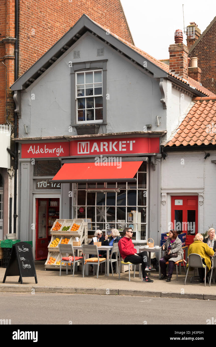 Aldeburgh Market cafe, delicatessen in Aldeburgh Suffolk UK with people eating outside at tables and chairs al fresco Stock Photo