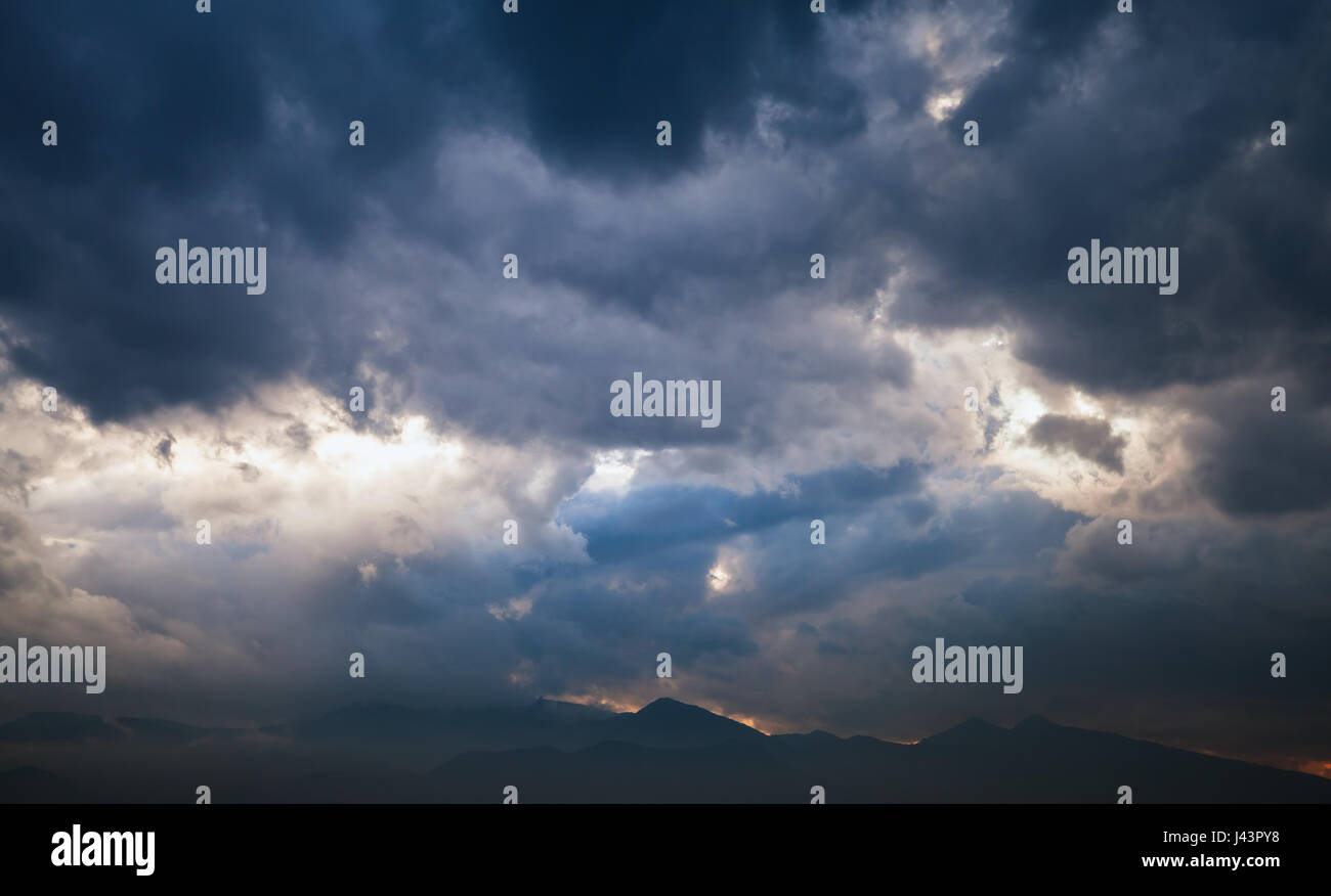 Dramatic tropical sky with dark clouds at late evening, abstract nature background Stock Photo