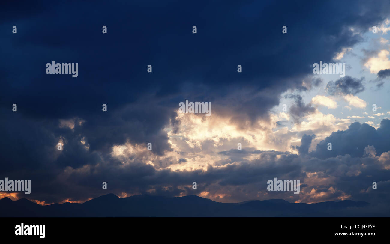 Dramatic tropical sky with dark clouds at early morning, abstract nature background Stock Photo