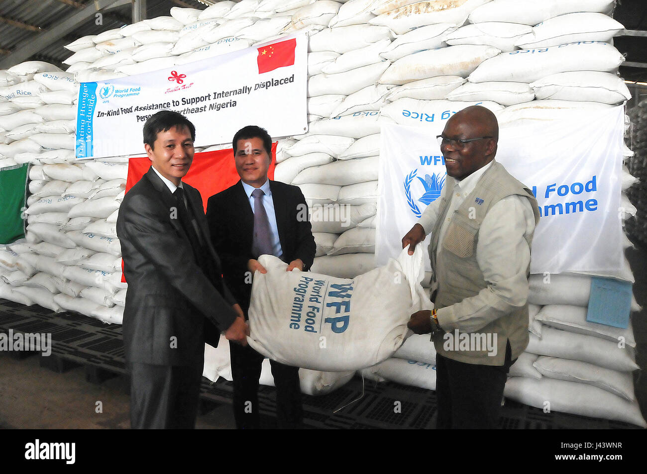 Maiduguri, Nigeria. 8th May, 2017. Chinese ambassador to Nigeria Zhou Pingjian (C) and Ron Sibanda (R), country director and representative of the United Nations World Food Program (WFP) attend a hand-over ceremony at the warehouse of WFP near Maiduguri, Nigeria, on May 8, 2017. China on Monday provided Nigeria with 5 million U.S. dollars in emergency humanitarian aid as part of its support for relief efforts by the United Nations World Food Program (WFP) in northeast Nigeria. Credit: Zhang Baoping/Xinhua/Alamy Live News Stock Photo