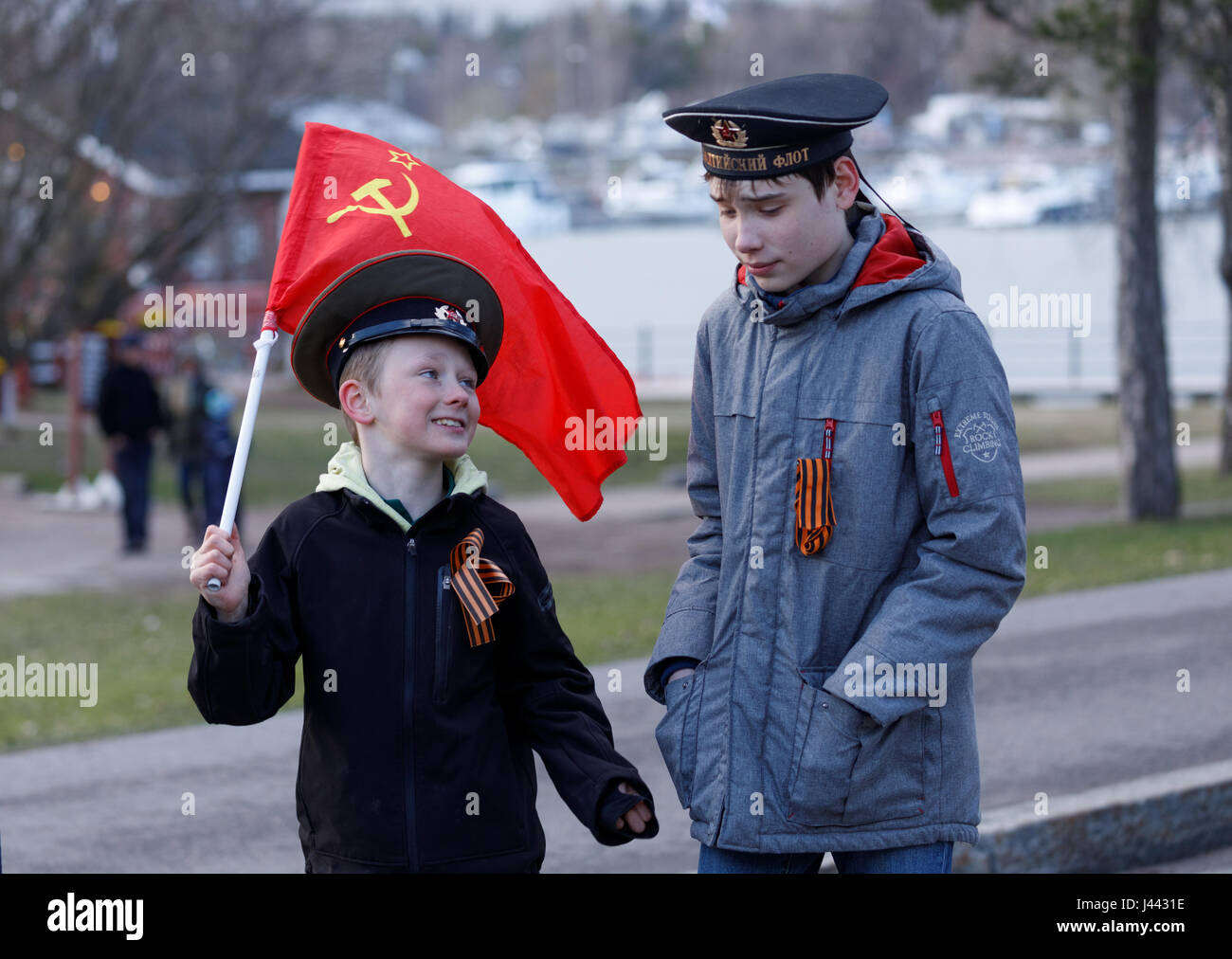 Helsinki, Finland. 9th May, 2017.Two boys wearing Soviet style uniform caps and carrying Soviet flag celebrating the anniversary of German surrender in Berlin of 9 May 1945 in a procession seeking publicity to a new Russian organization in Finland. Credit: Hannu Mononen/Alamy Live News Stock Photo