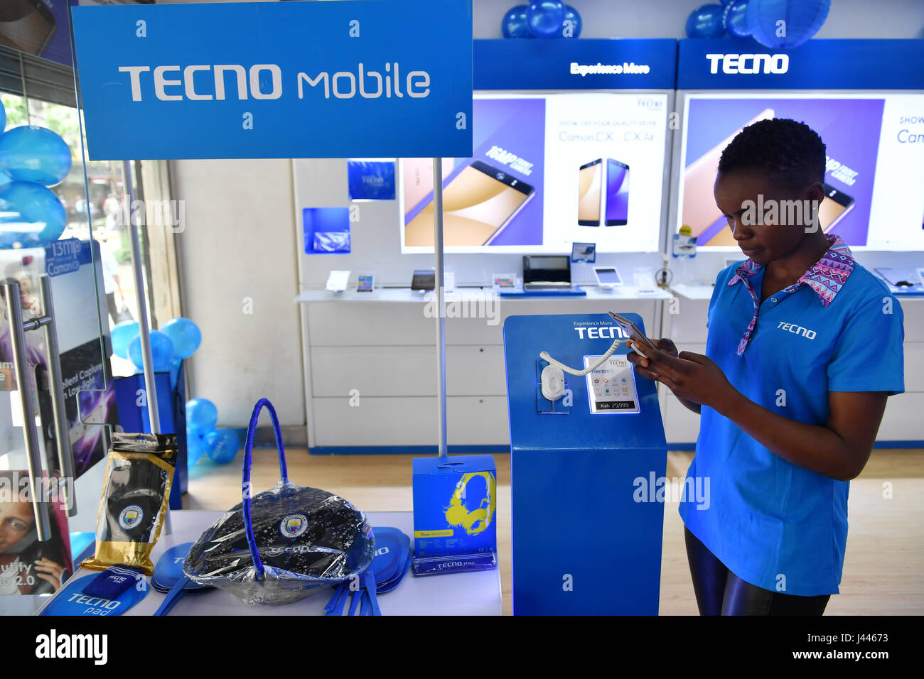 (170510) -- NAIROBI, May 10, 2017 (Xinhua) -- A staff waits for customers at a mobile phone shop in downtown Nairobi, capital of Kenya, on May 9, 2017. Chinese mobile phone manufacturer Tecno Mobile sales reached 25 million devices, including 9 million smartphones in 2015, helping it to sustain the most 'popular ' brand status in Africa. (Xinhua/Sun Ruibo) (jmmn) Stock Photo