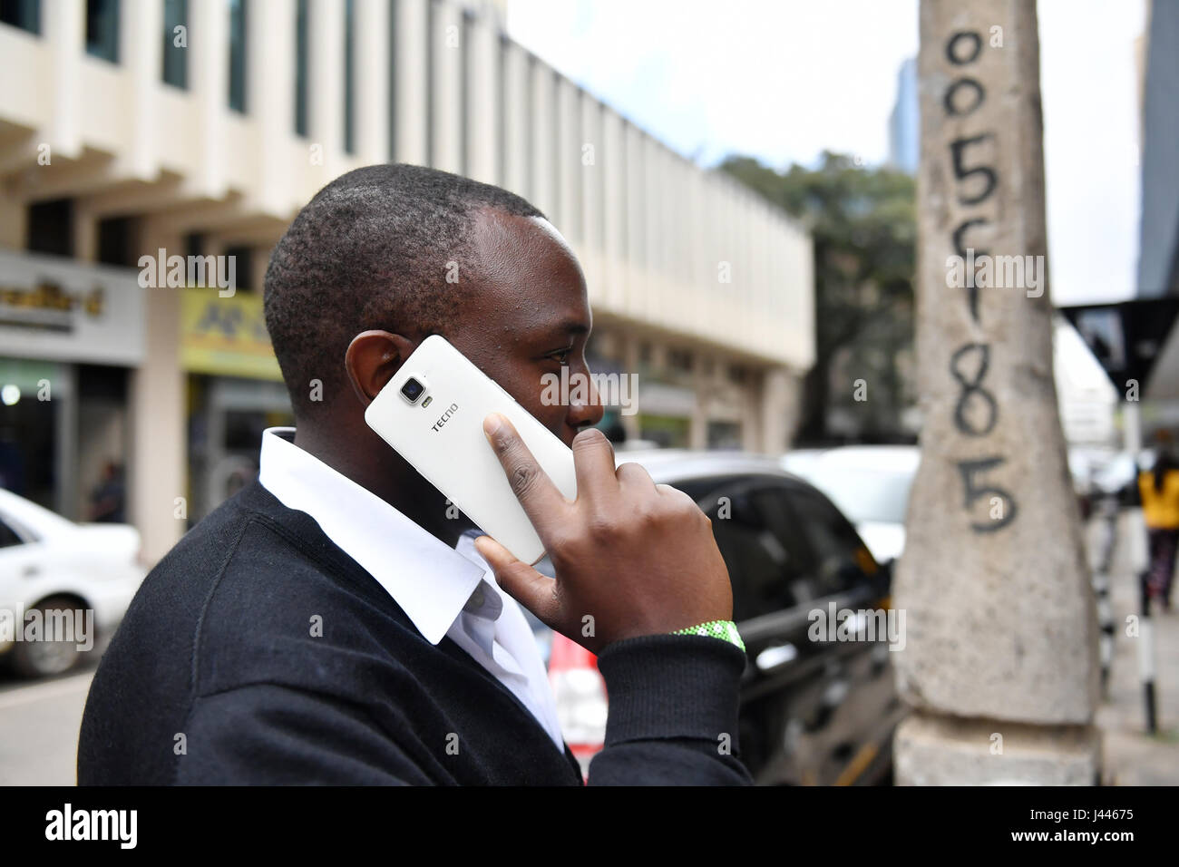 (170510) -- NAIROBI, May 10, 2017(Xinhua) -- A man uses Tecno mobile phone in downtown Nairobi, capital of Kenya, May 9, 2017. Chinese mobile phone manufacturer Tecno Mobile sales reached 25 million devices, including 9 million smartphones in 2015, helping it to sustain the most 'popular' brand status in Africa. (Xinhua/Sun Ruibo) (jmmn) Stock Photo