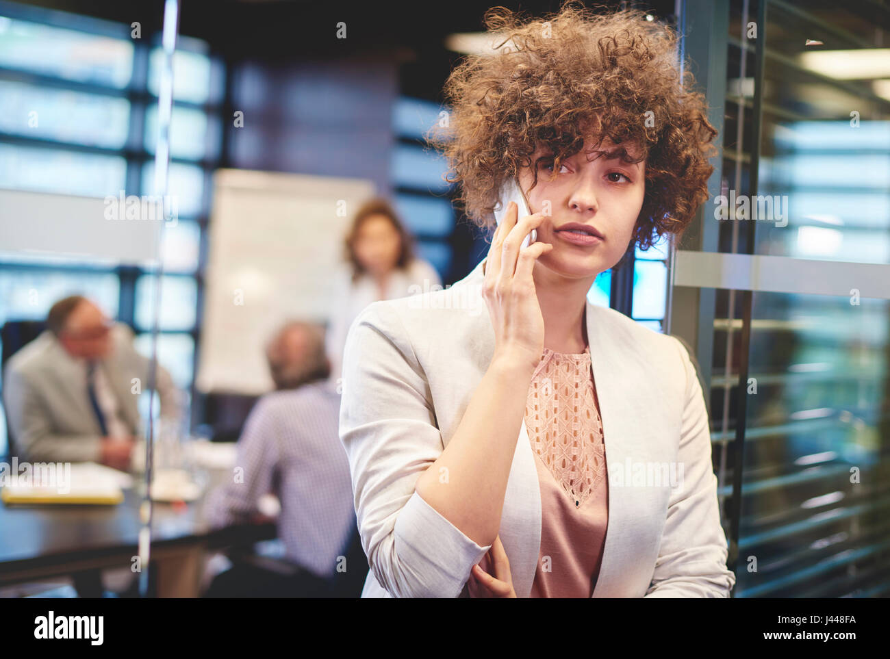 Business woman having a phone call at work Stock Photo