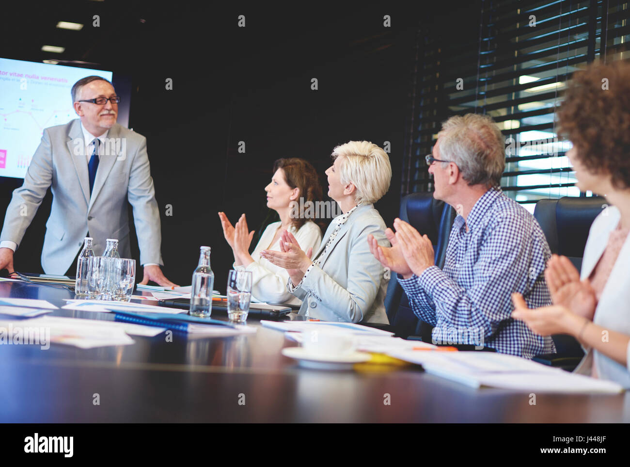Senior adults business admiring male public speaker Stock Photo