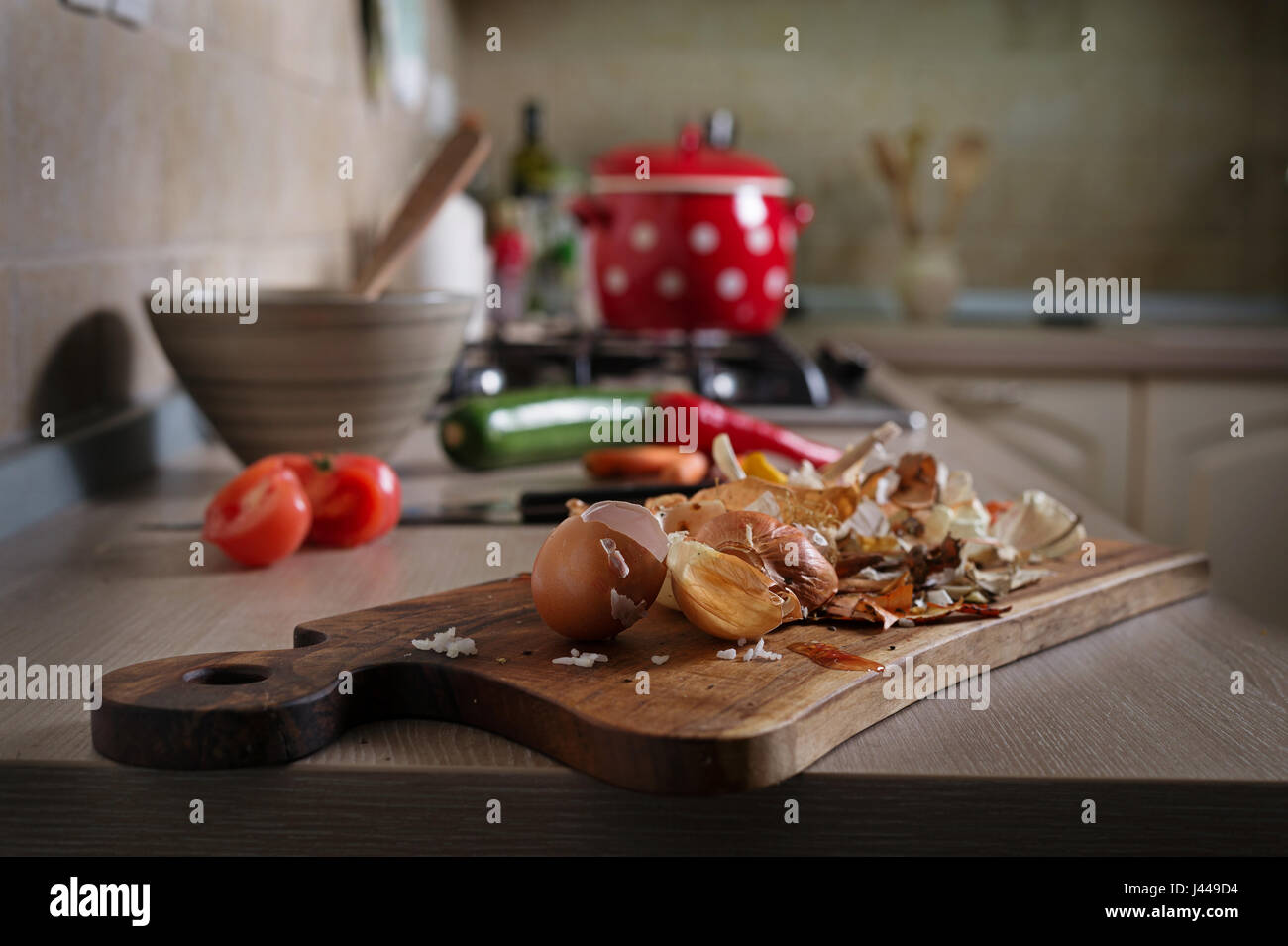 Food leftovers on kitchen counter. Household waste from vegetable ready to compost. Environmentally responsible behavior, ecology concept. Stock Photo