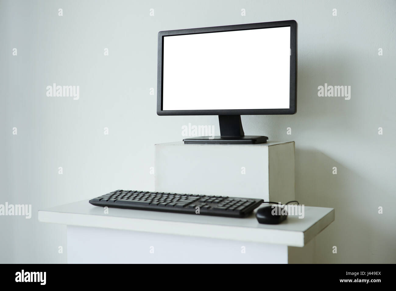 Mock up of computer screen on white table Stock Photo - Alamy