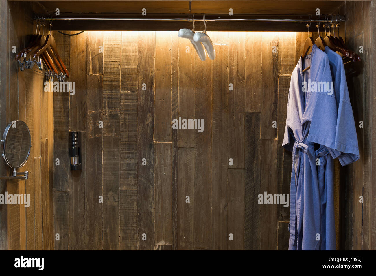 Blue twin bathrobe in wooden wardrobe of luxury hotel Stock Photo Alamy