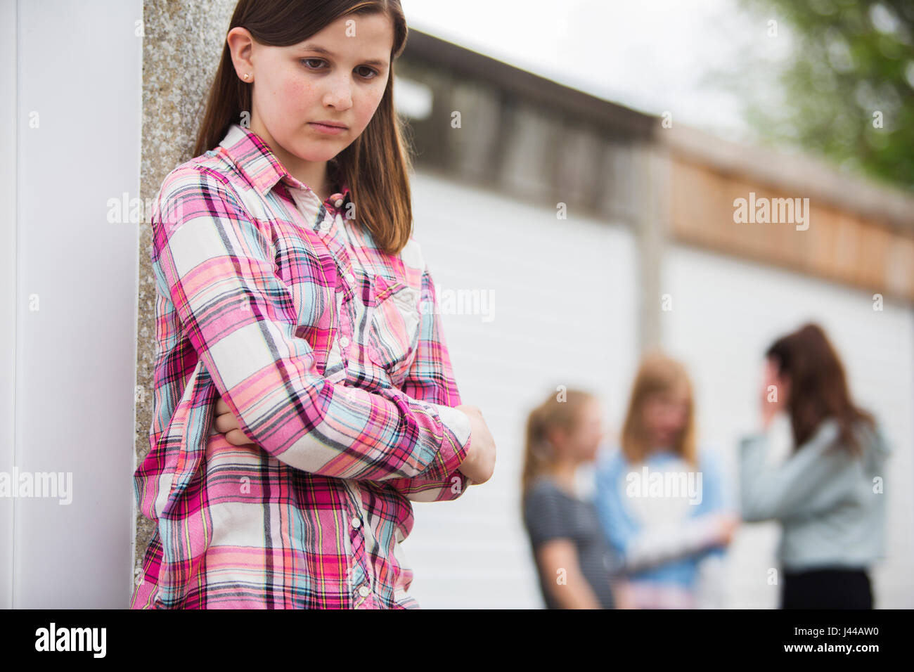 Sad Pre Teen Girl Feeling Left Out By Friends Stock Photo