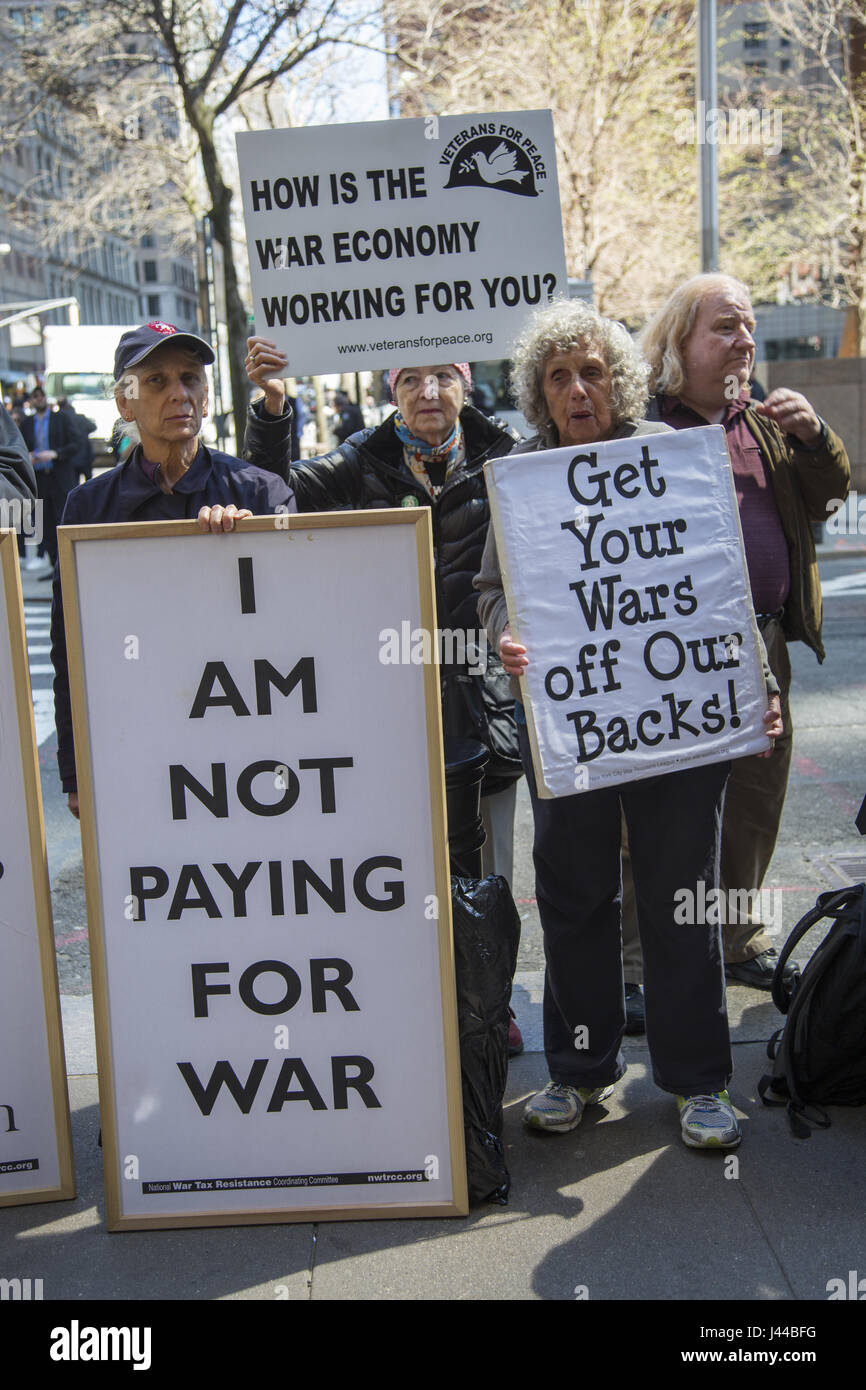 Antiwar protesters demonstrate outside the Internal Revenue Service (IRS) in Manhattan on tax day sending the message we don't want our tax money going to war. Stock Photo