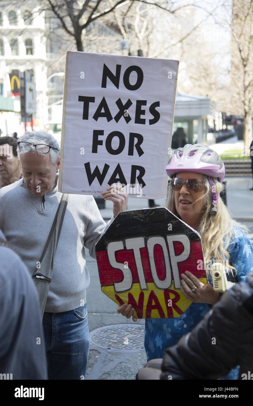 Antiwar protesters demonstrate outside the Internal Revenue Service (IRS) in Manhattan on tax day sending the message we don't want our tax money going to war. Stock Photo