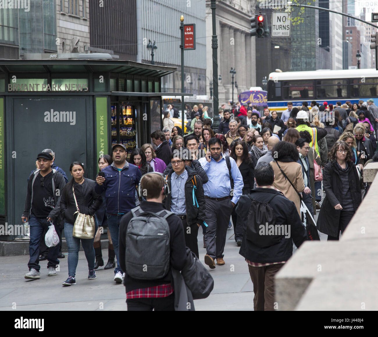 The sidewalk is always crowded on 42nd Street along the New York Public Library between 5th and 6th Avenues in NYC. Stock Photo
