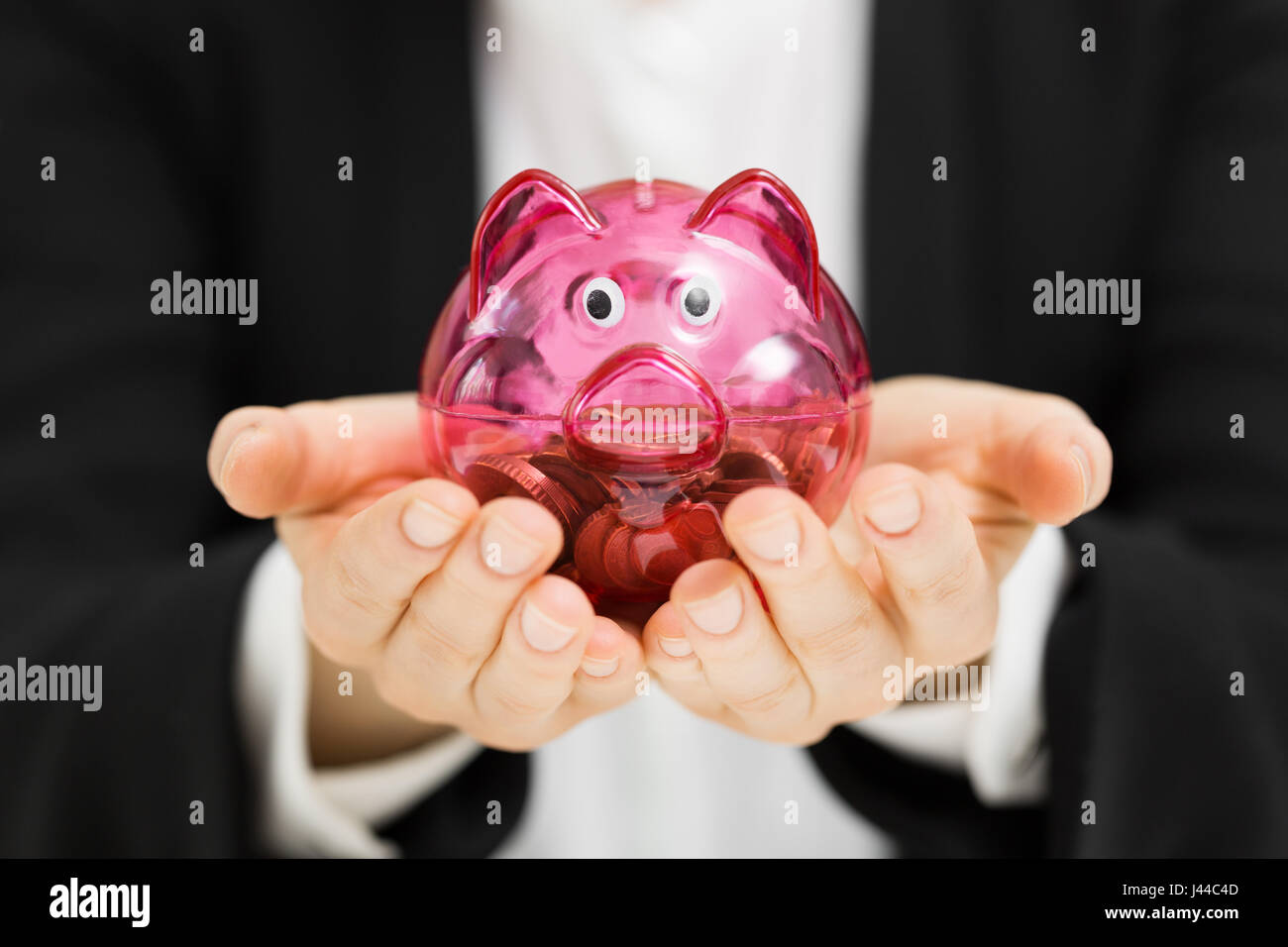 business profit savings concept - woman holding piggy bank in hands Stock Photo