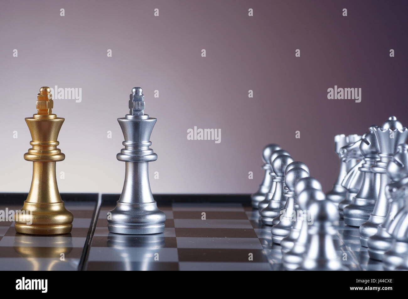 Silver king facing golden king chess on gradient background - leadership, team, successful and business concept Stock Photo