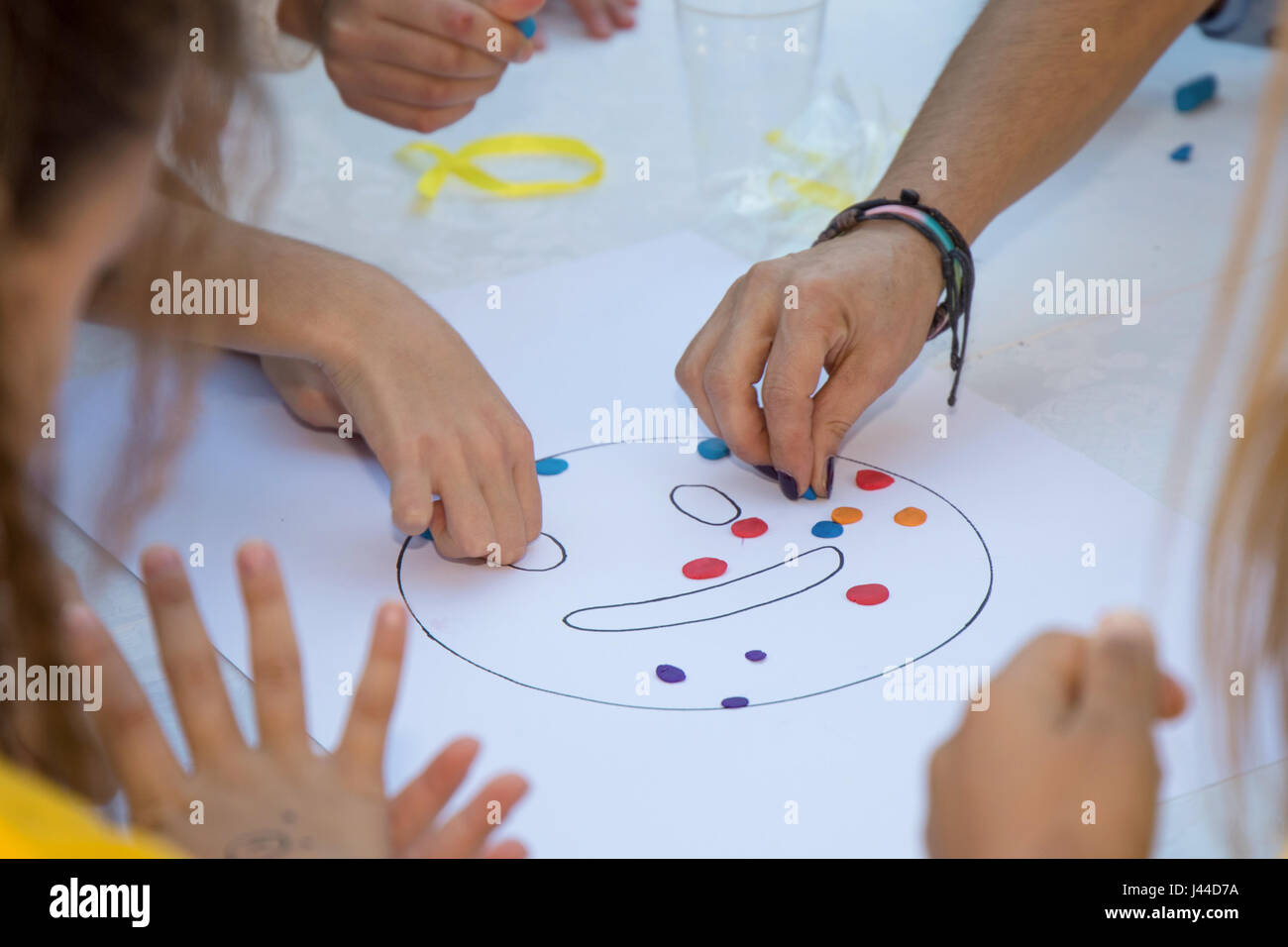 Kids playing with play doh Stock Photo - Alamy