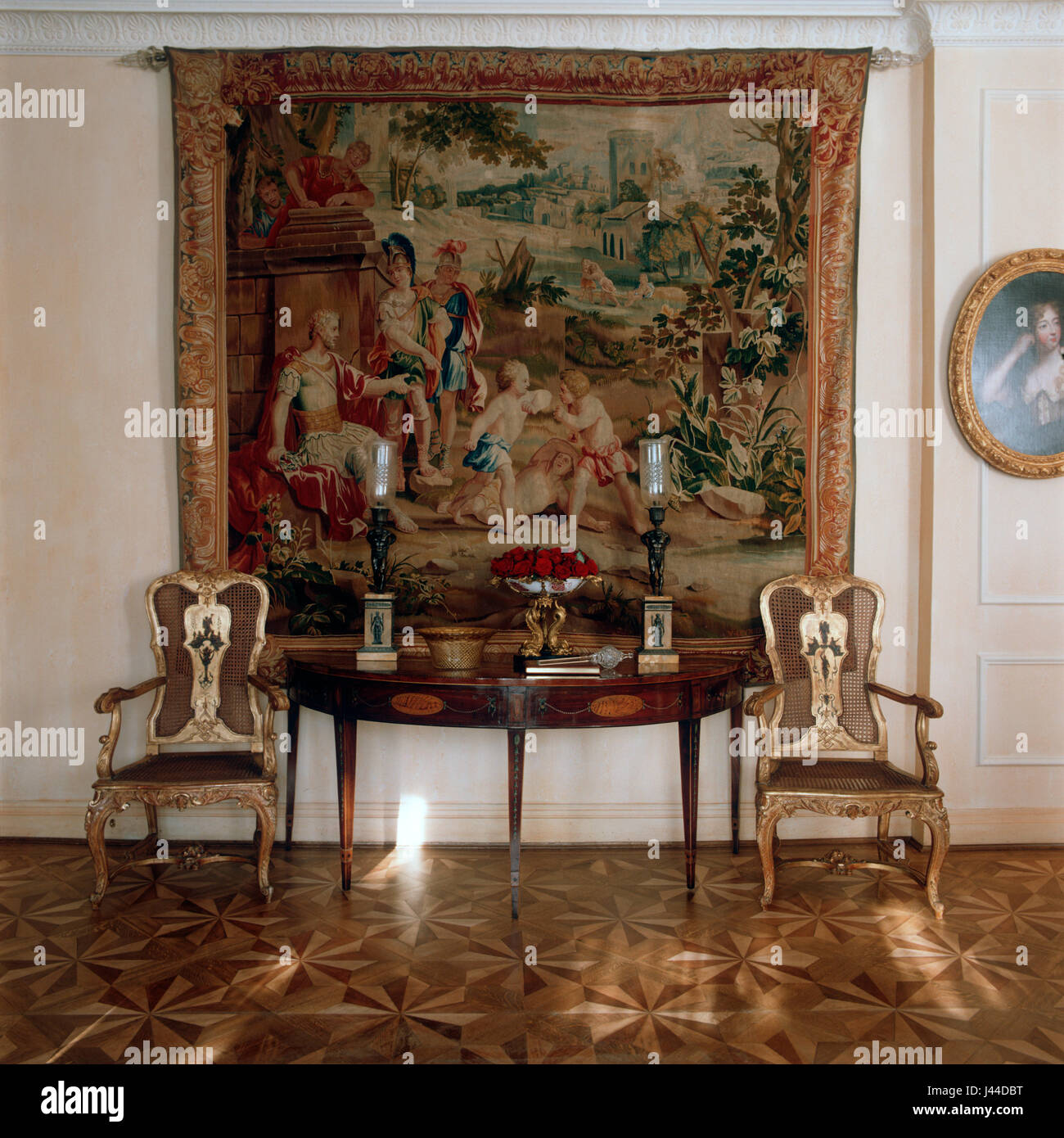 Elaborate parquetry floor with 18th century tapestry and gilded Marquises chairs circa 1835 Stock Photo