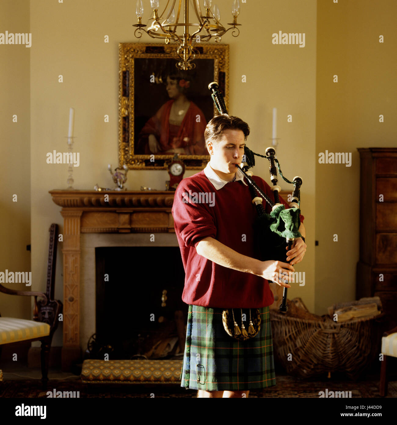 Man playing bagpipes in Scottish castle Stock Photo
