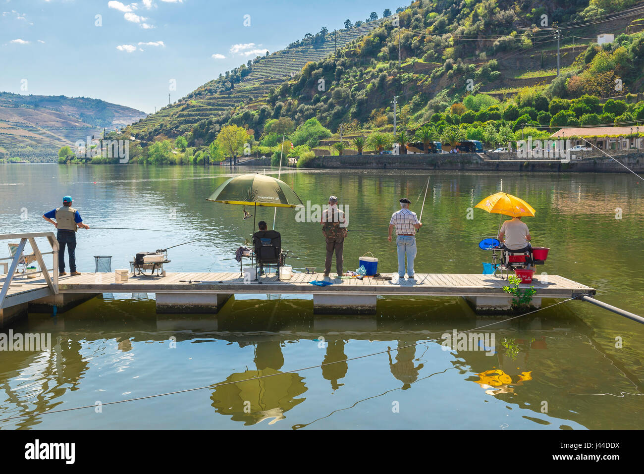 Men fishing, a group of middle aged men fishing in Portugal, Europe. Stock Photo