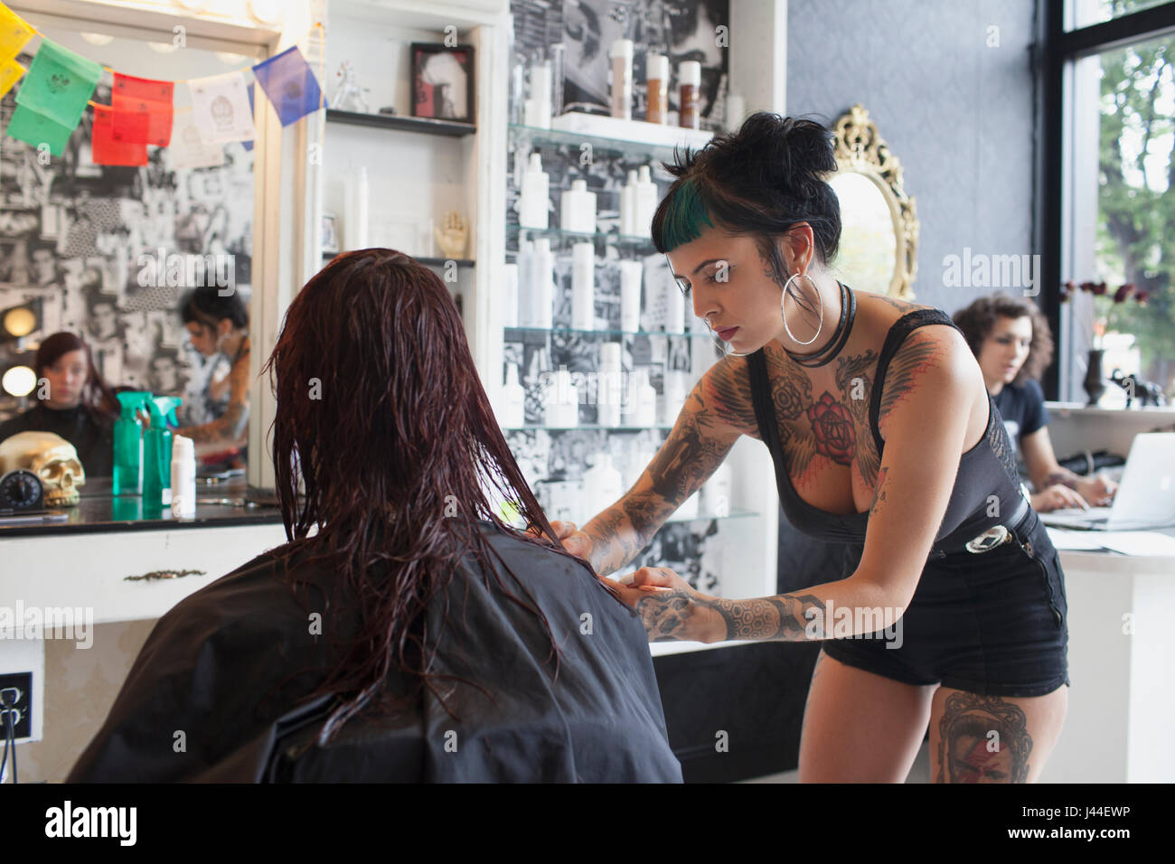 A hair dresser styling a customer's hair. Stock Photo