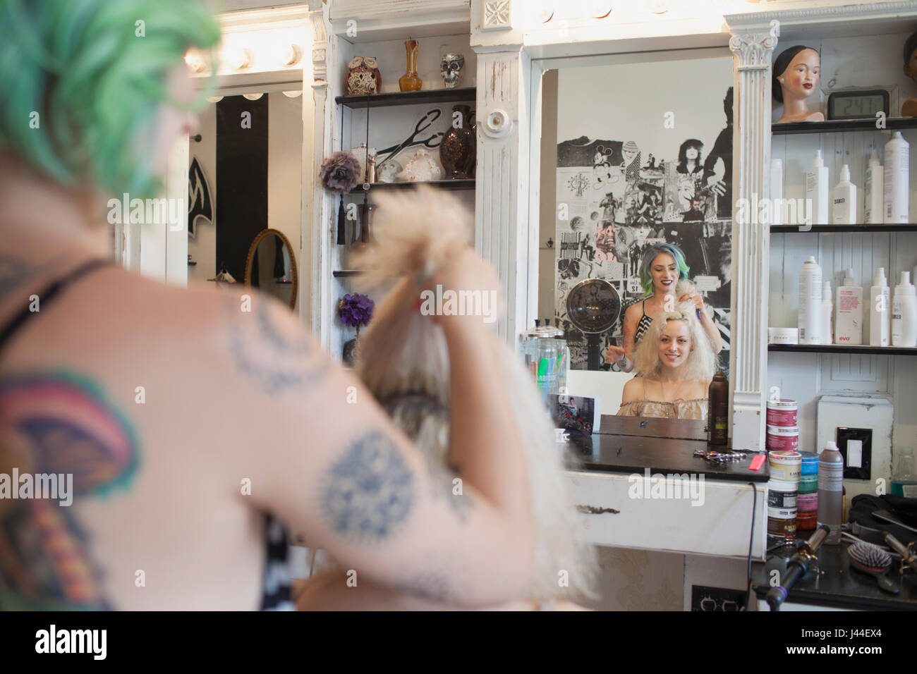 A hair dresser styling a customer's hair. Stock Photo