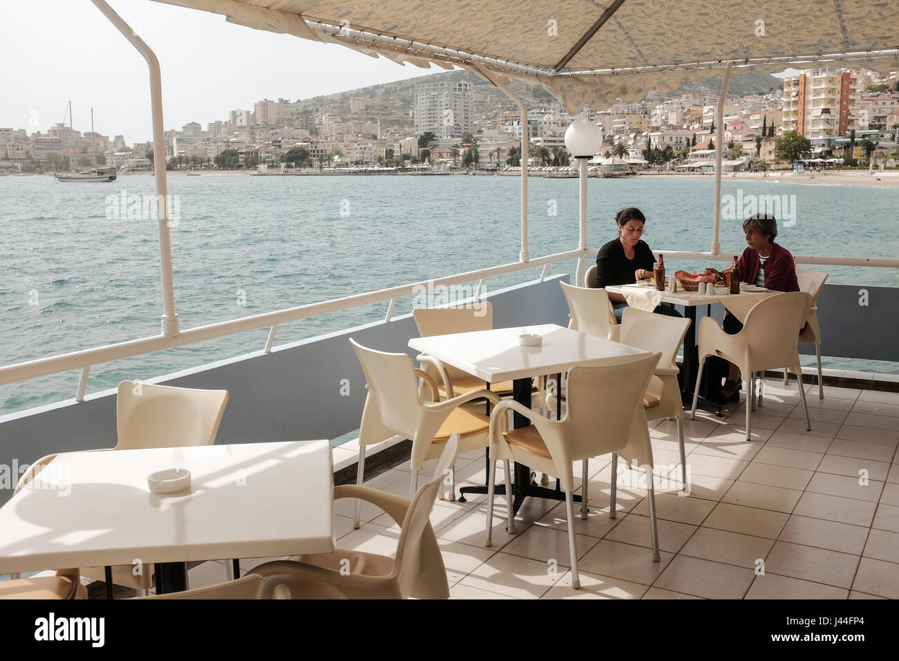 A restaurant in Saranda, a coastal town in Vlore County, southern Albania. Situated on the Ionian Sea in the central Mediterranean, it is known for its deep blue waters of the Mediterranean and in recent years has seen a steady increase in tourism. Stock Photo