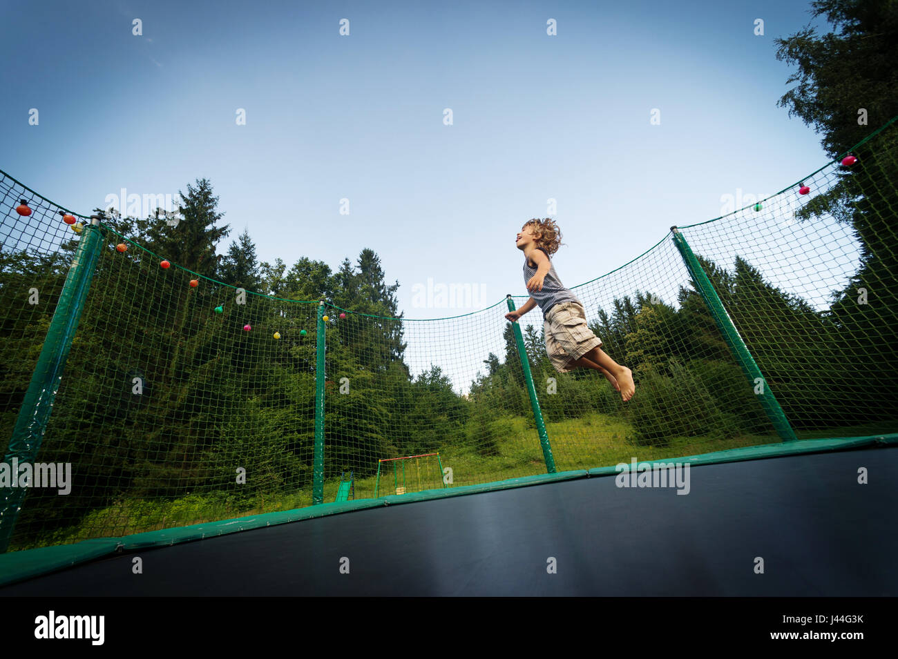Trampoline child jumping happy hi-res stock photography and images - Alamy