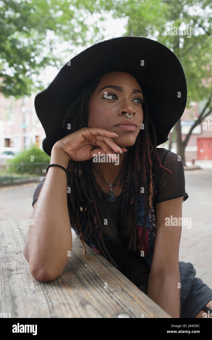 A young woman wearing a black hat Stock Photo - Alamy