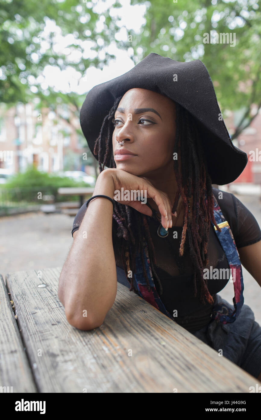 A young woman wearing a black hat Stock Photo - Alamy