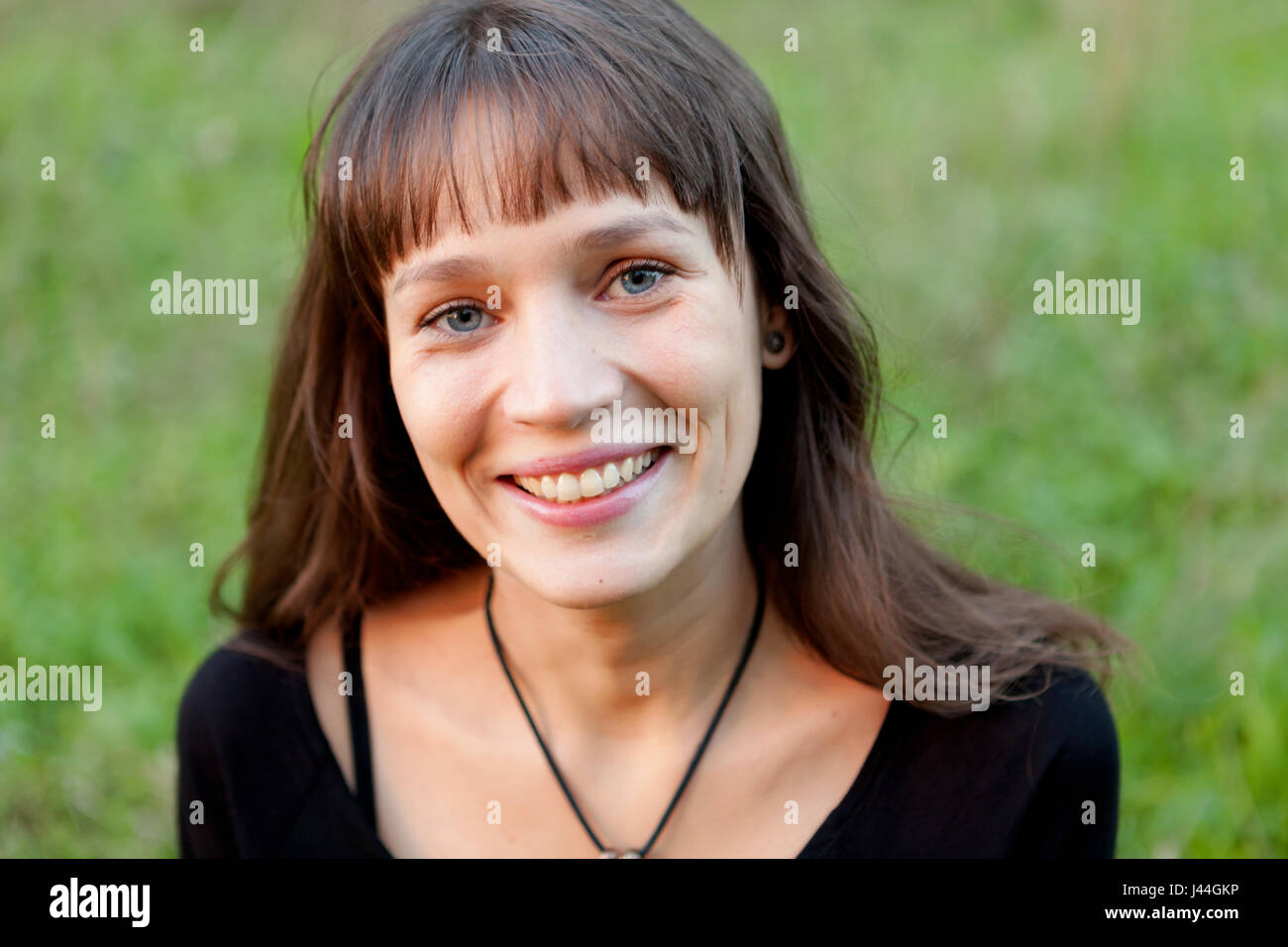 Beautiful woman with blue eyes in the park Stock Photo Alamy
