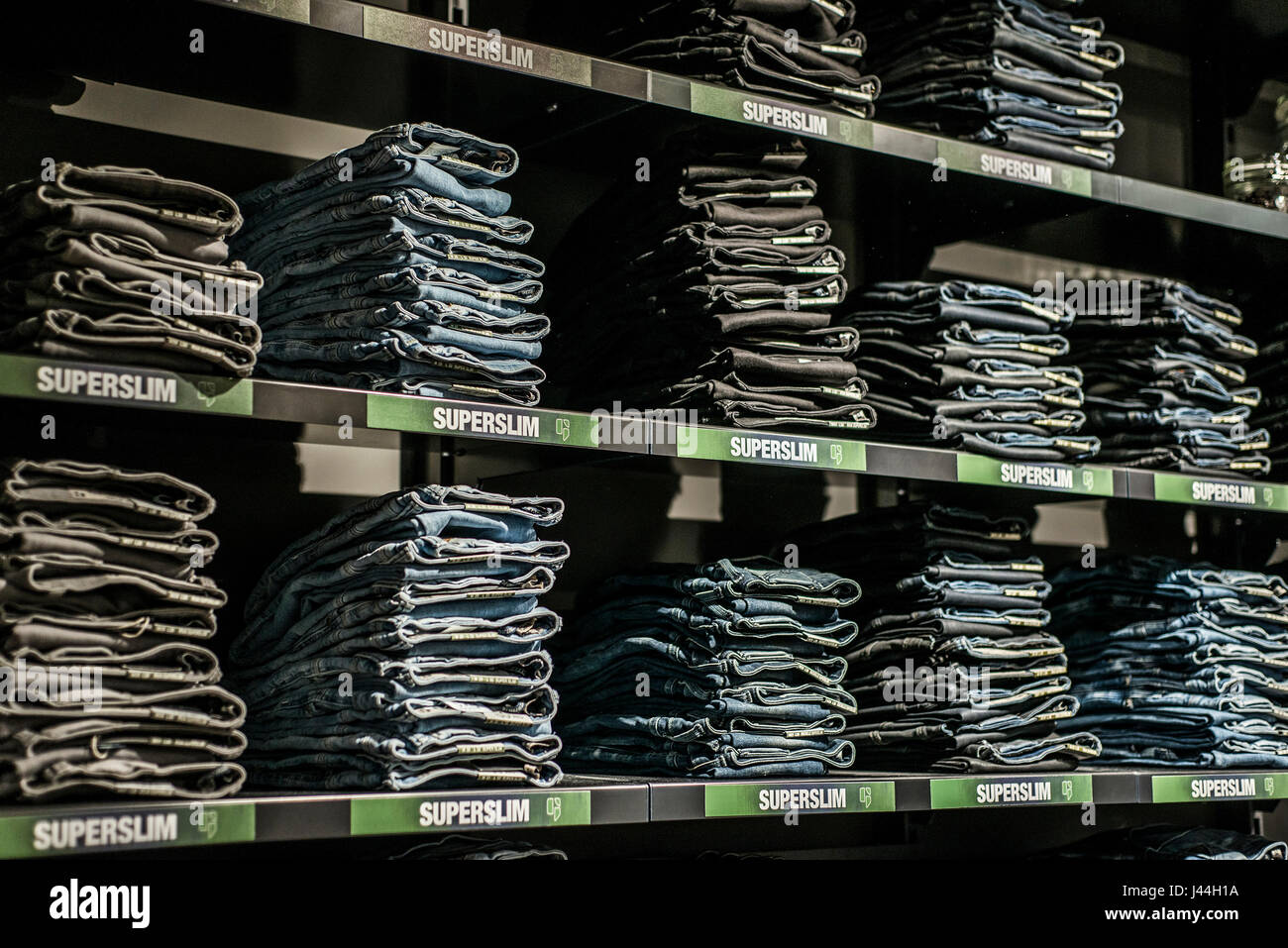 Roermond, Netherlands 07.05.2017 - Stack of blue Jeans at the Diesel Store  in the Mc Arthur Glen Designer Outlet shopping area Stock Photo - Alamy