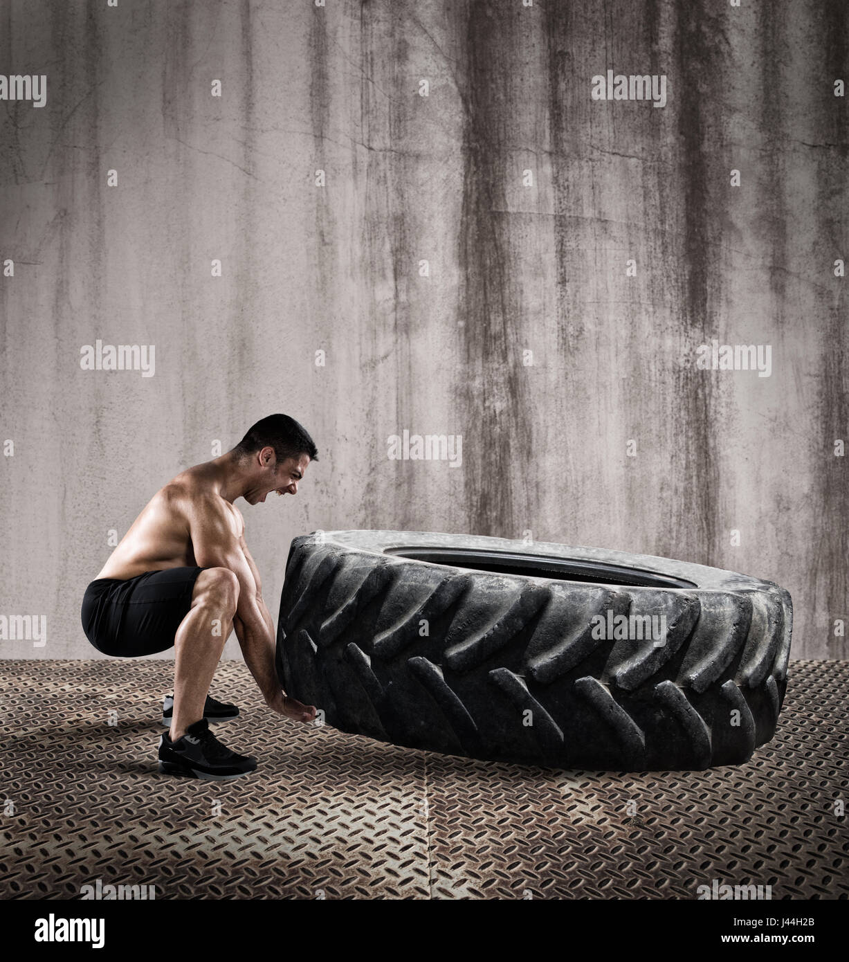 Workout with a big tire Stock Photo
