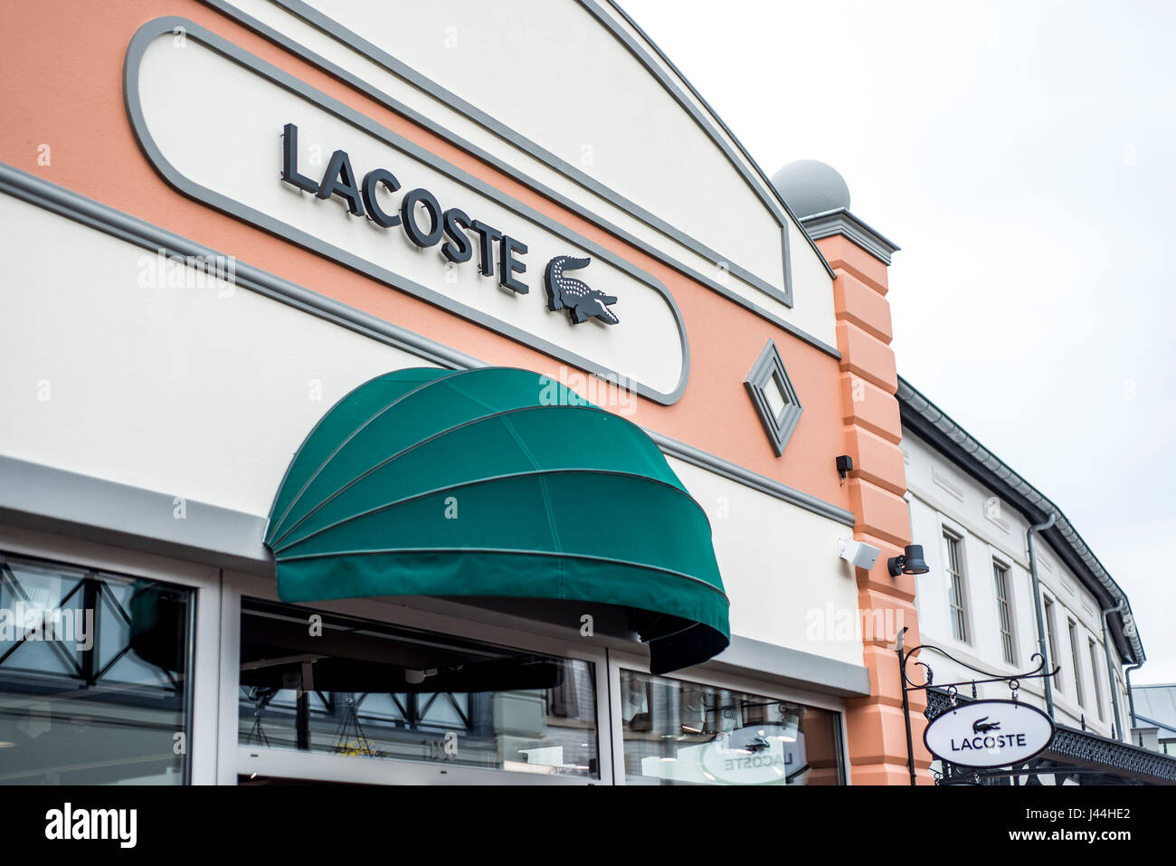 Roermond, Netherlands 07.05.2017 - Logo of Lacoste Store in the Mc Arthur  Glen Designer Outlet shopping area Stock Photo - Alamy