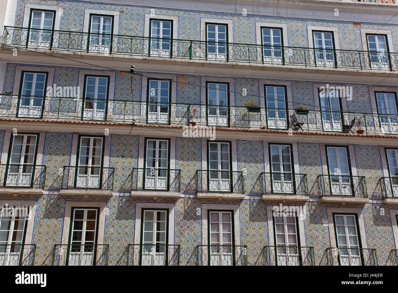 Portugal, Estremadura, Lisbon, Bairro Alto, Typical apartment building with tiled exterior, balconies and french windows. Stock Photo
