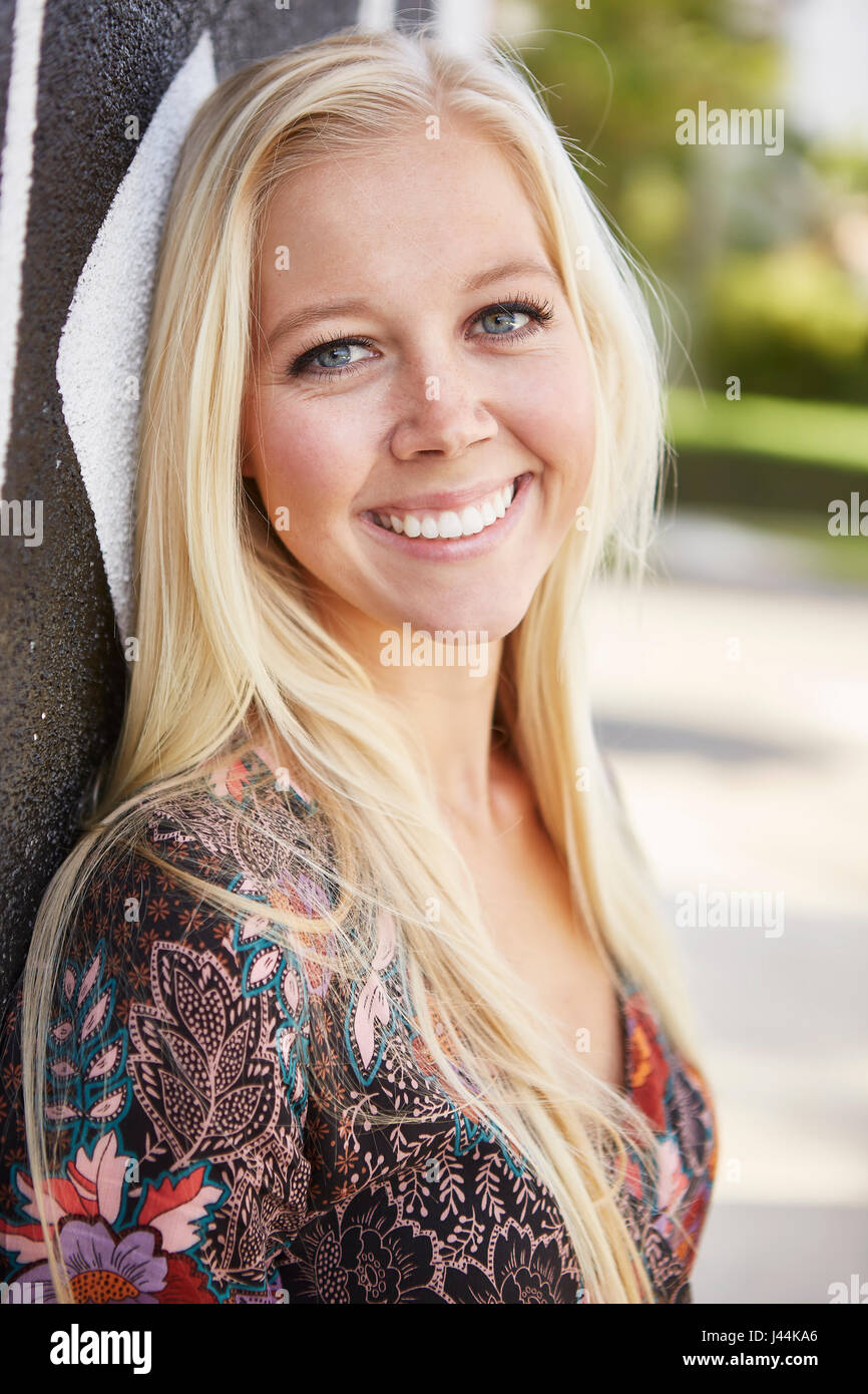 Portrait of a happy young blonde woman smiling at the camera Stock ...