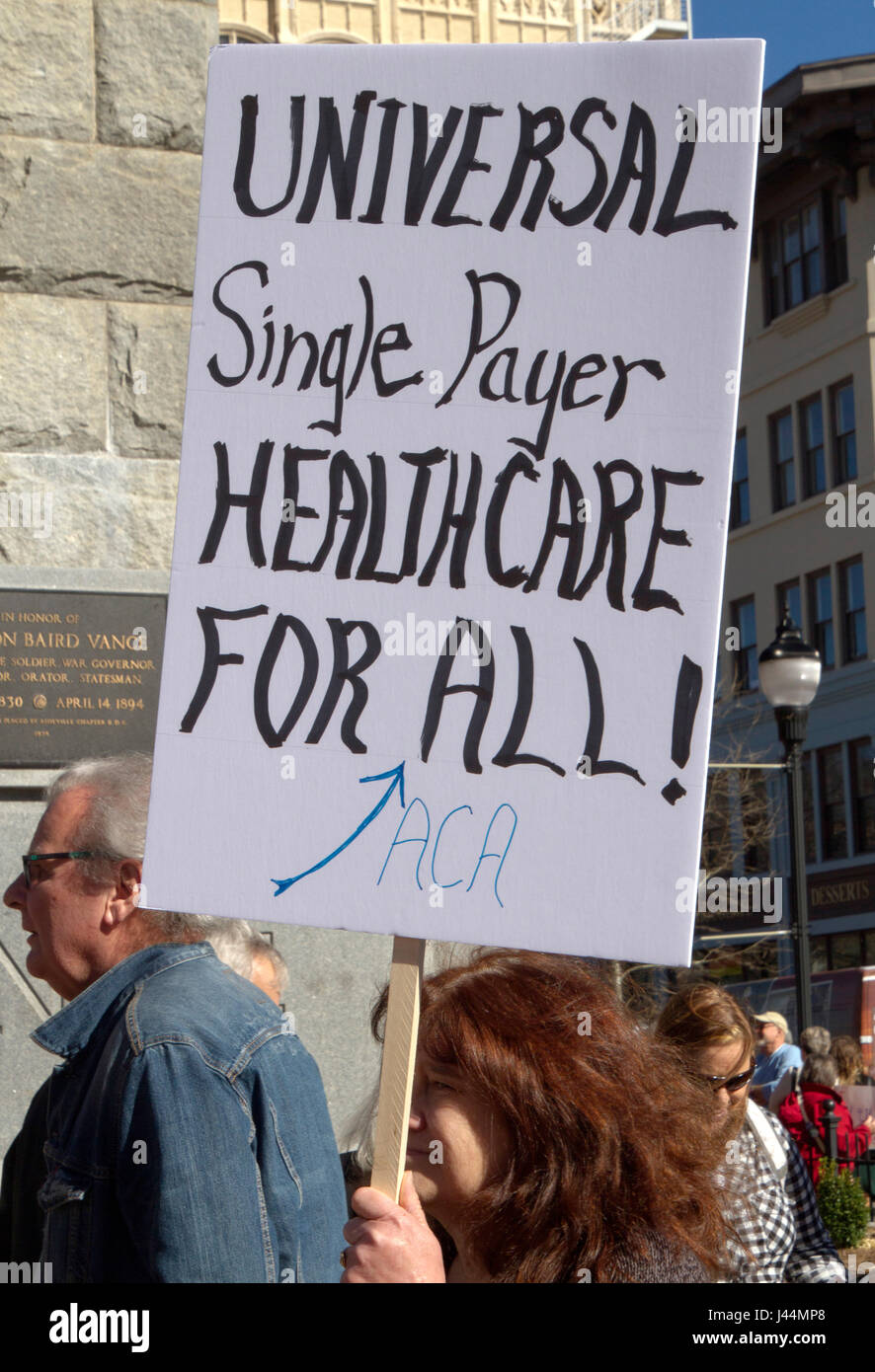 Asheville, North Carolina, USA - February 25, 2017: Woman holds a csign saying 'Universal Single Payer Healthcare For ALL' at an Obamacare (Affordable Stock Photo