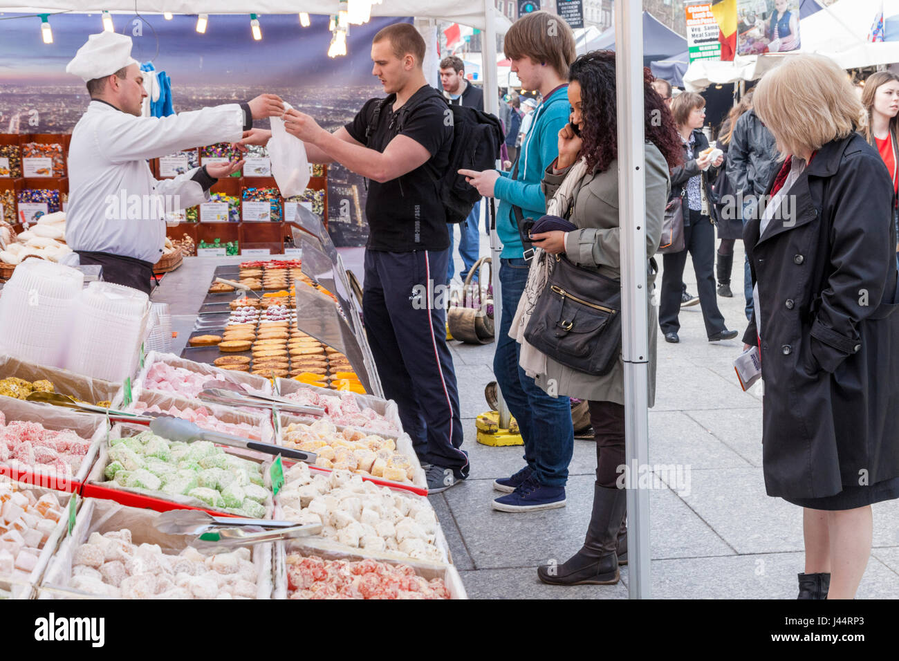 Selling sweets and pastries at an outdoor market stall, Nottingham, England, UK Stock Photo
