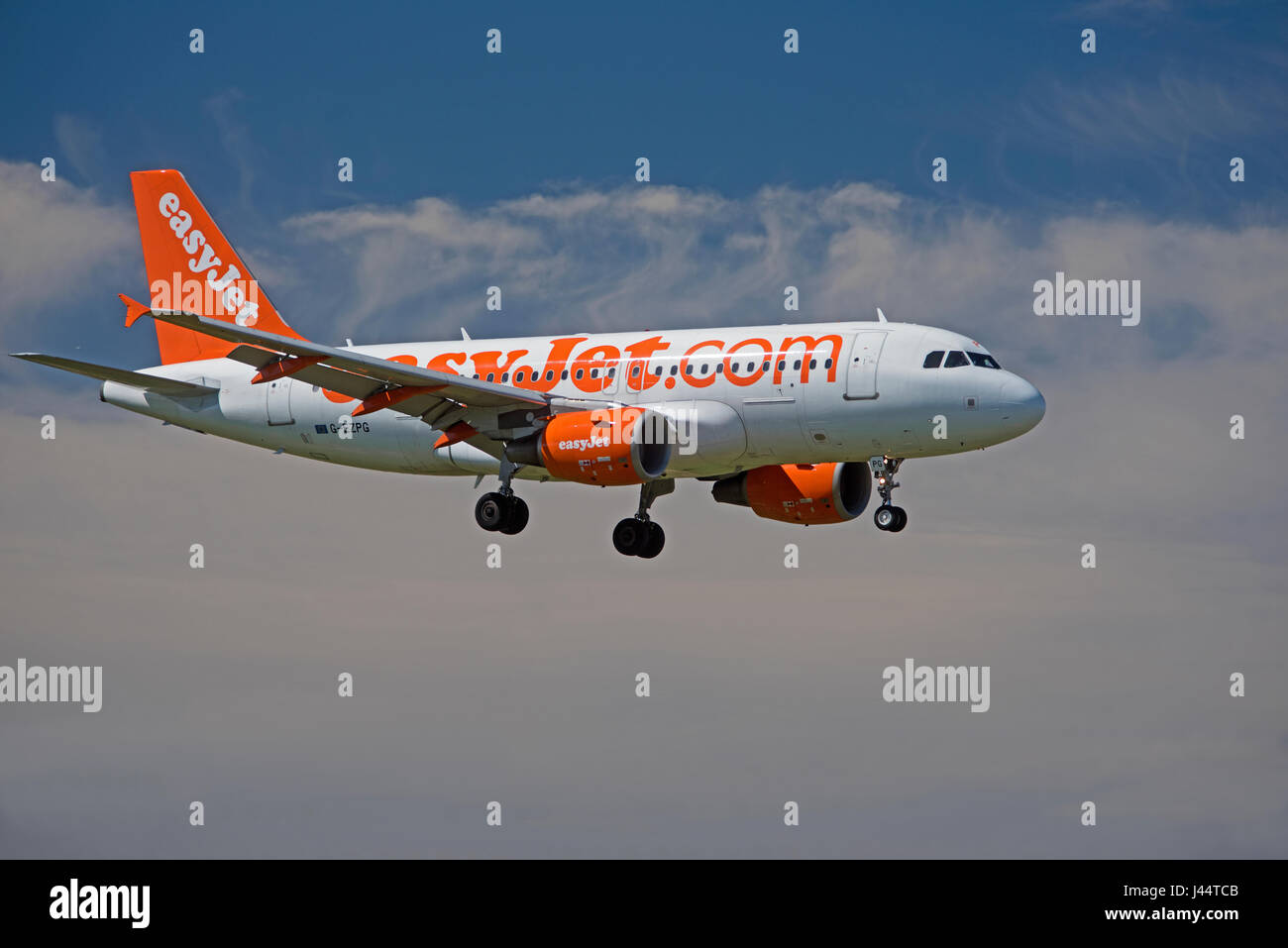 Easyjet commercial passenger Airbus A 320-214 aircraft in its unmistakeable company orange livery Stock Photo