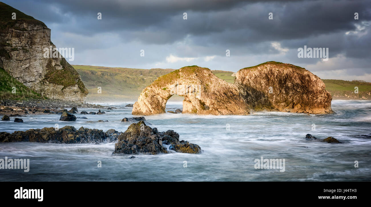Rock Arch at east end of Whitepark Bay  near Ballintoy and Bushmills on the Antrim coast of Northern Ireland Stock Photo