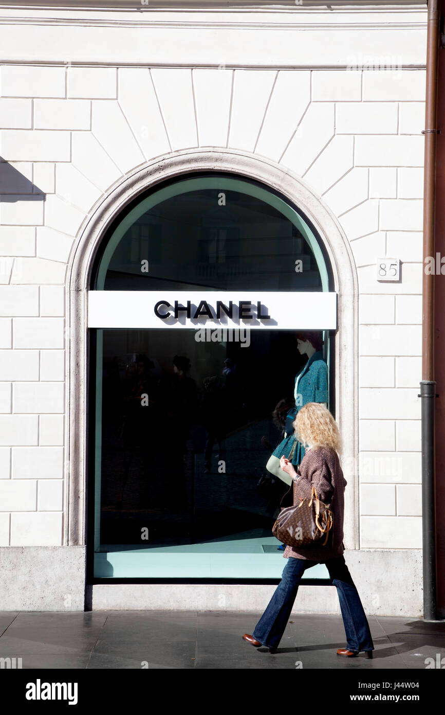 Pedestrian walk past of a Chanel store at Piazza di Spagna, Rome Italy Stock Photo