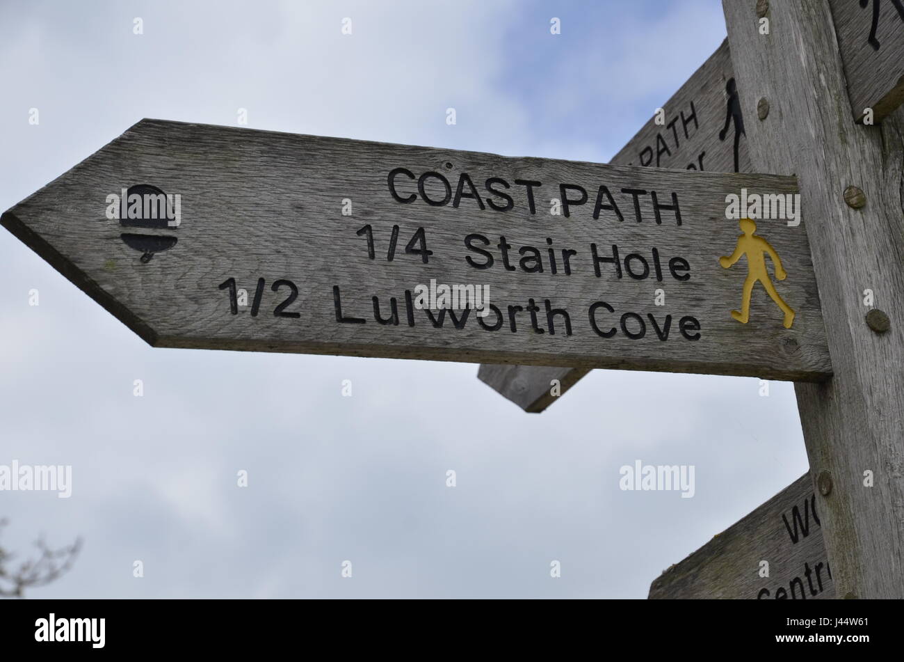 A footpath sign to Stair Hole and Lulworth Cove on the South West Coastal Path in West Lulworth, Dorset Stock Photo