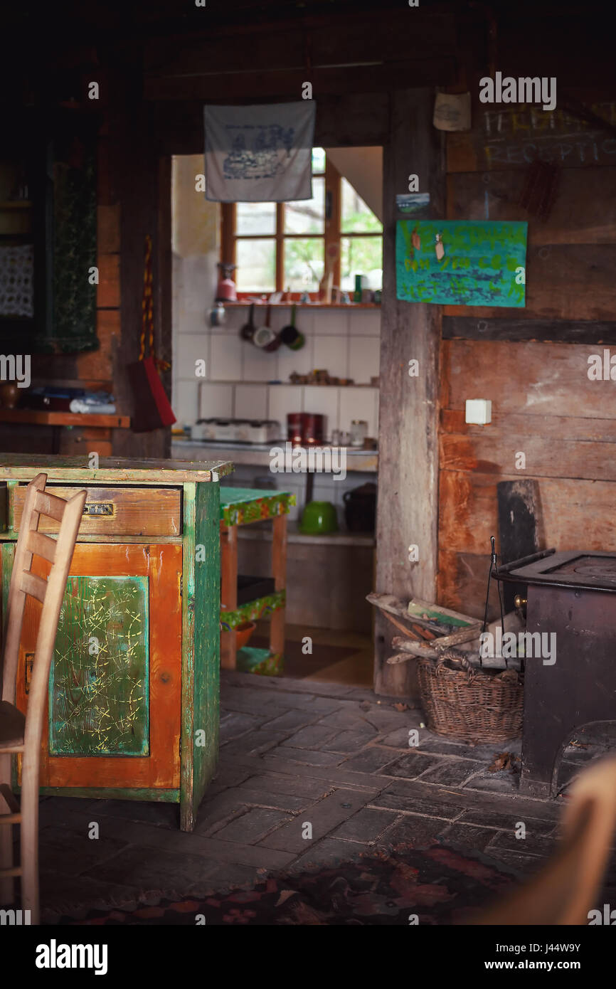 Details of an interior of an old wooden Serbian house, everything is handmade from furniture to walls. Stock Photo