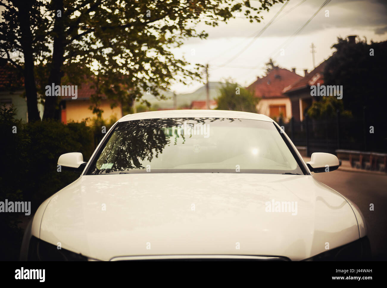 Front view of a modern car parked in a street. Stock Photo