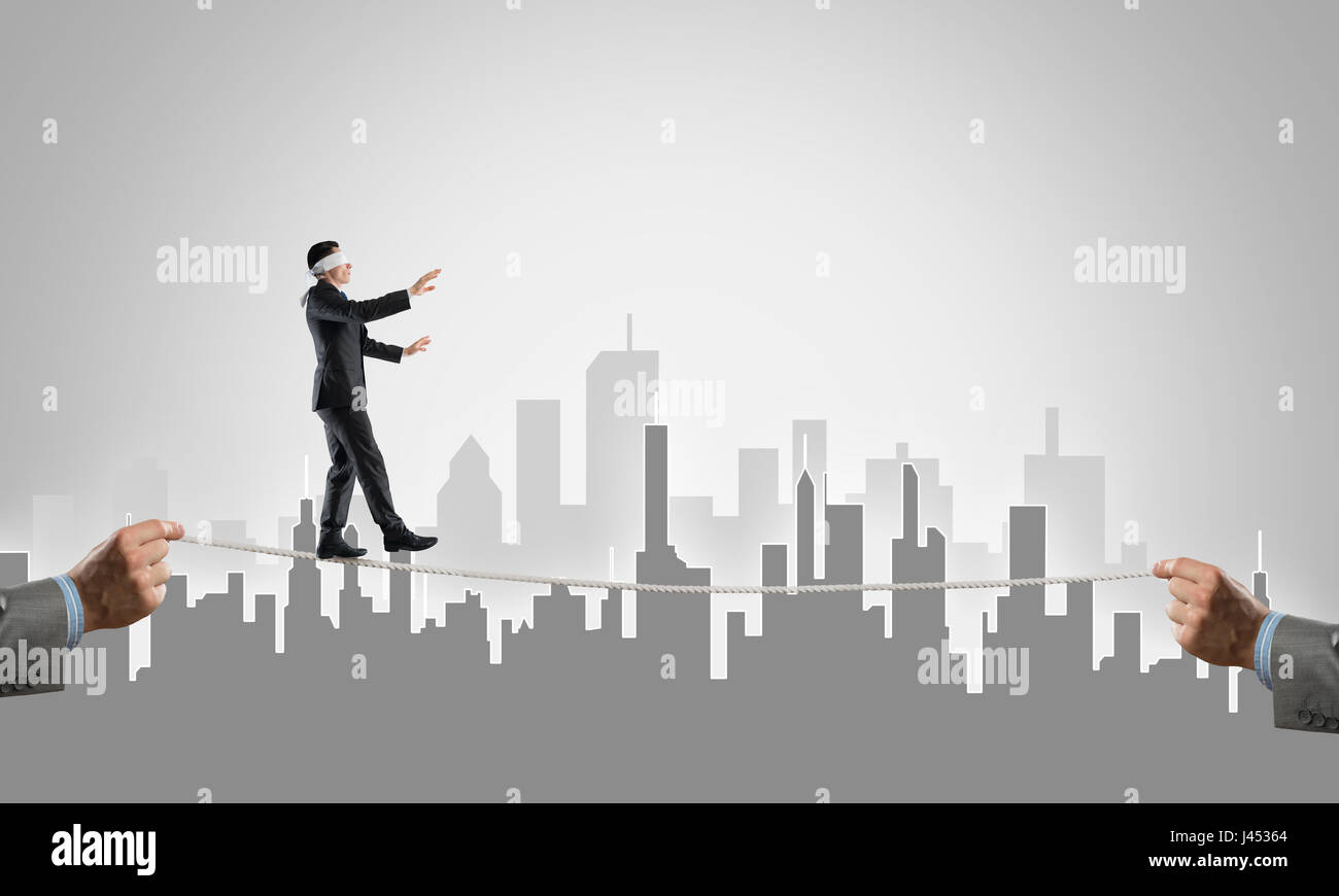 Business concept of risk support and assistance with man balancing on ...