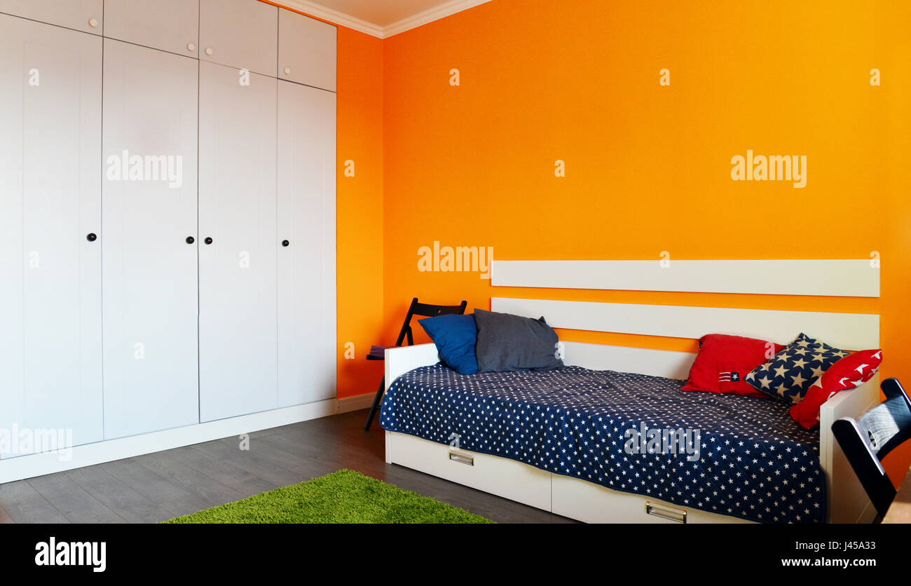 Kids Bedroom In Orange And Blue Colors With Two Beds And