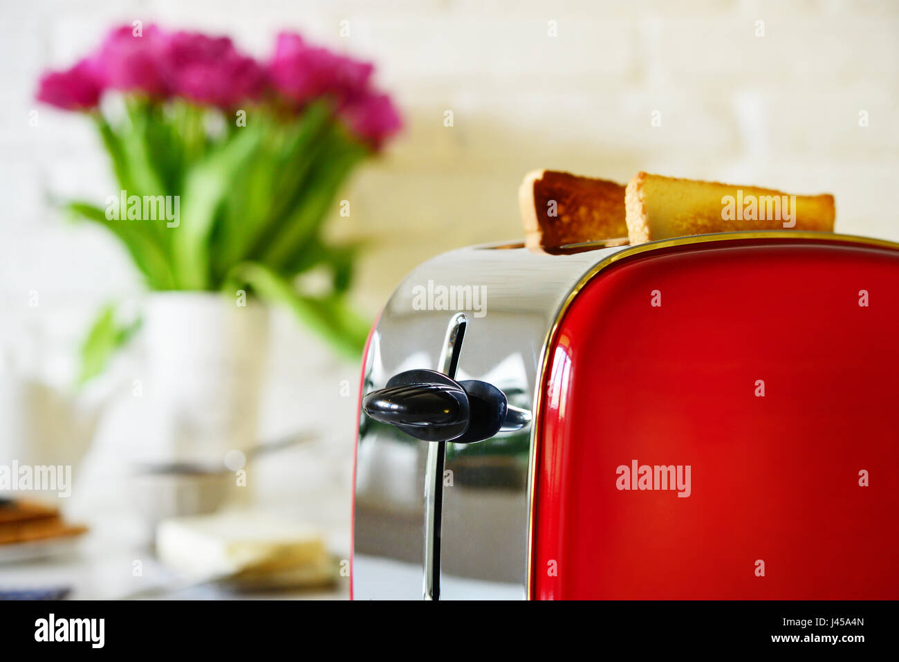 Toaster with bread in kitchen interior closeup Stock Photo